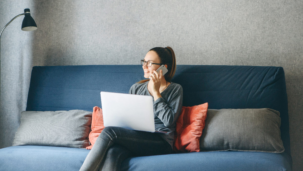 Woman talking on the phone in front of a computer